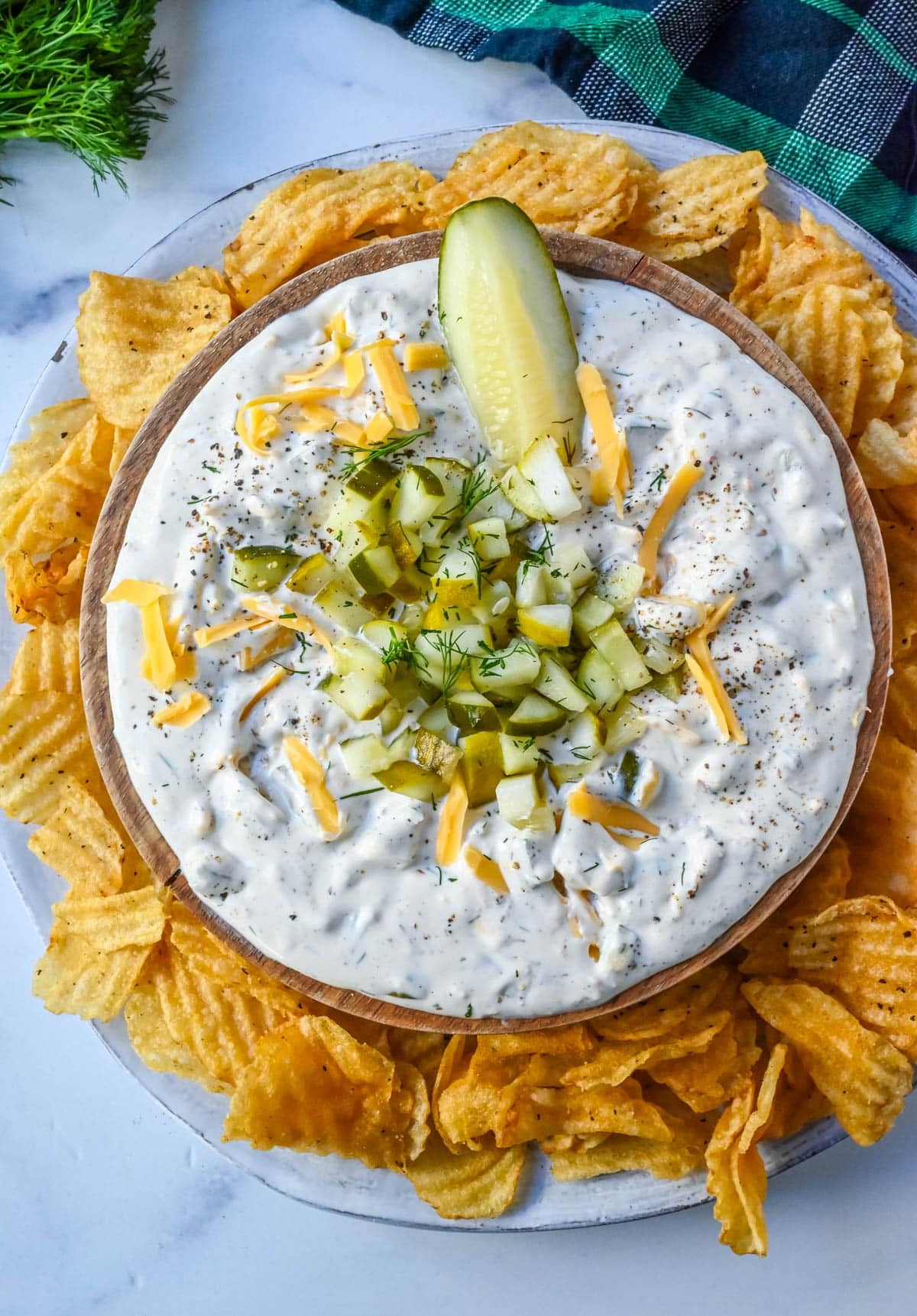 Pickle Dip — Creamy, Tangy, and Completely Addictive 27 overhead flat lay of pickle dip ingredients including cream cheese block, Greek yogurt container, fresh dill, whole dill pickles, garlic cloves, and a small bowl of pickle brine on a marble surface