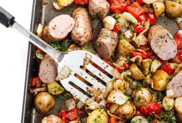 Sheet Pan Sausage and Peppers — The Easy, Crowd-Pleasing One-Pan Dinner You'll Make on Repeat 26 Sheet pan sausage and peppers with roasted potatoes and onions on a large baking sheet, golden and caramelized, garnished with fresh parsley