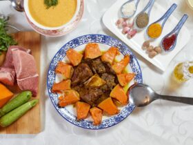 Slow Cooker Beef Stew — Fork-Tender Beef with Carrots, Potatoes, and Rich Herb Gravy 36 Slow cooker beef stew served in a rustic white bowl with fork-tender beef chunks, golden carrots, soft potatoes, and glistening herb gravy, garnished with fresh thyme on a wooden table