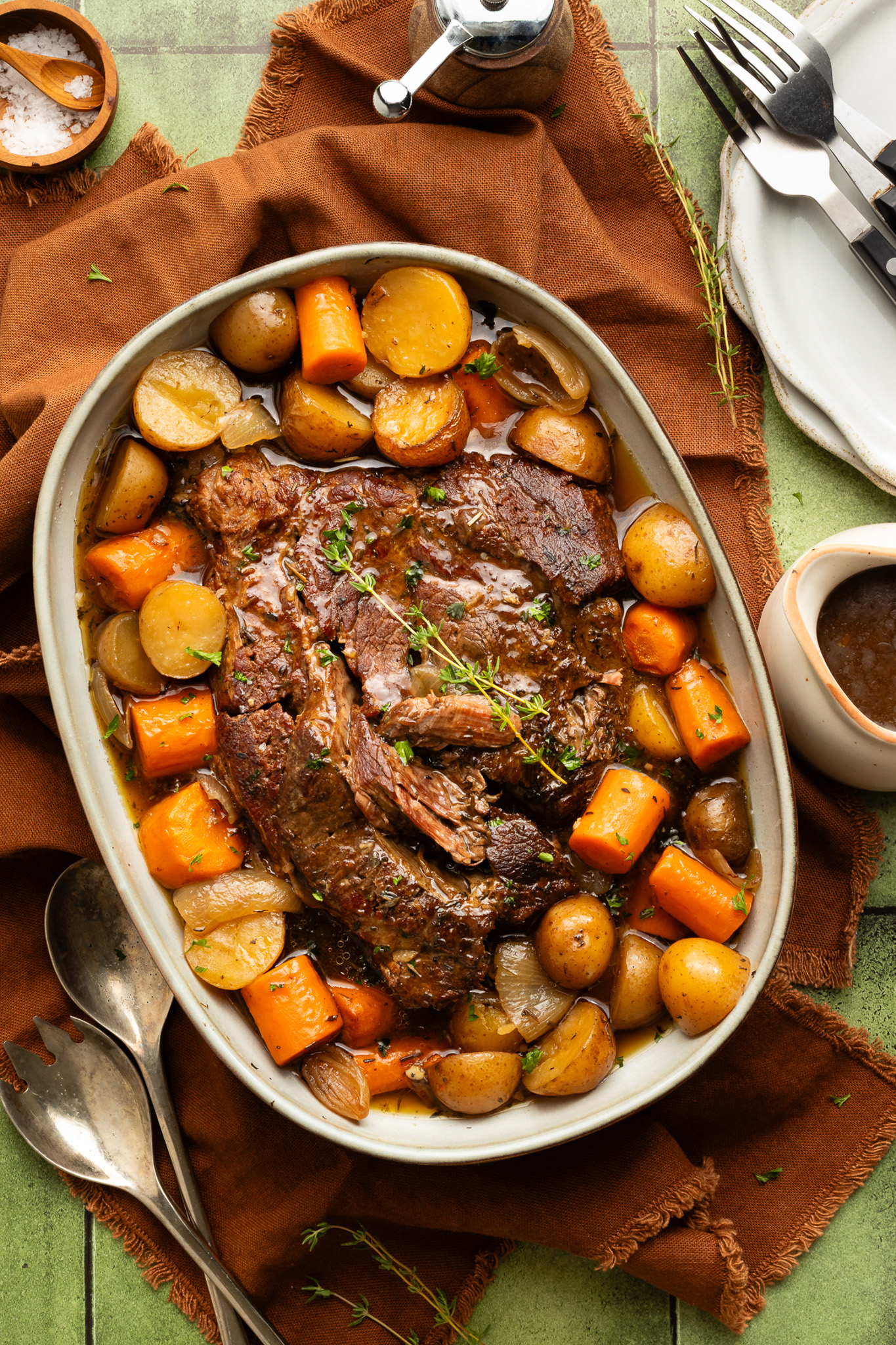 Slow Cooker Pot Roast — Classic Chuck Roast with Root Vegetables and Savory Gravy 28 Close-up of slow cooker pot roast sliced and served with roasted carrots, potatoes, and rich brown gravy drizzled over the top in a rustic bowl