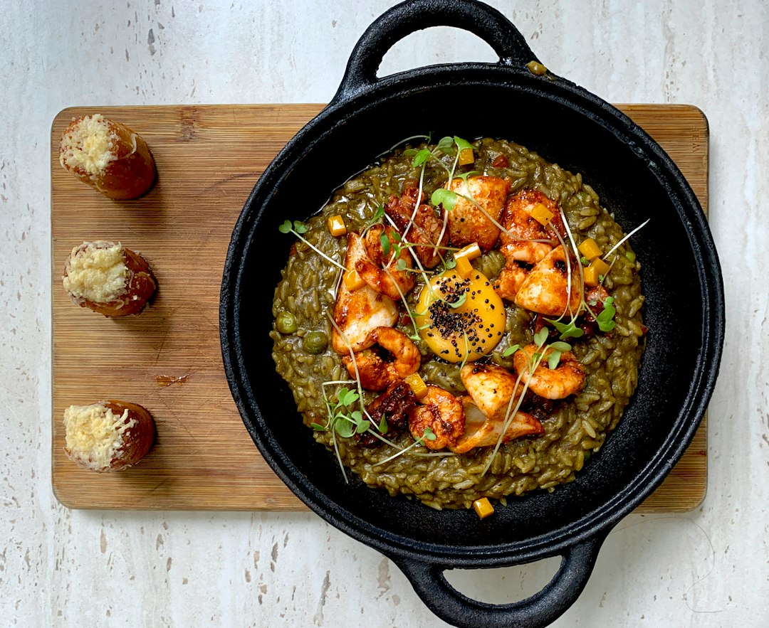 Spanish Paella — The Vibrant, Saffron-Scented One-Pan Feast You Need to Make 27 Step-by-step ingredients flat lay for Spanish Paella — raw shrimp, chicken thighs, bomba rice, saffron threads in a small bowl, smoked paprika, roasted red peppers, cherry tomatoes, garlic, and fresh parsley on a marble surface