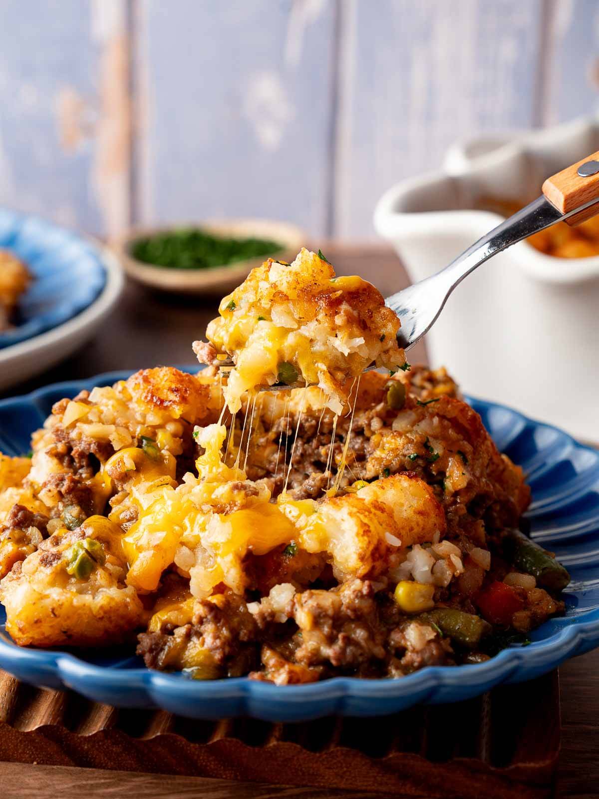 Tater Tot Casserole — The Ultimate Crispy, Cheesy Ground Beef Comfort Bake 27 Step-by-step ingredients flat lay showing raw ground beef, frozen tater tots, shredded cheddar, cream of mushroom soup, diced onion, and garlic on a light marble surface