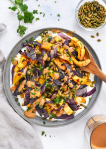 Air Fryer Butternut Squash Fries (Crispy, Healthy & Ready in 25 Minutes) 13 Butternut squash cut into uniform fry-shaped sticks on a wooden cutting board, surrounded by small bowls of smoked paprika, cumin, olive oil, and Greek yogurt