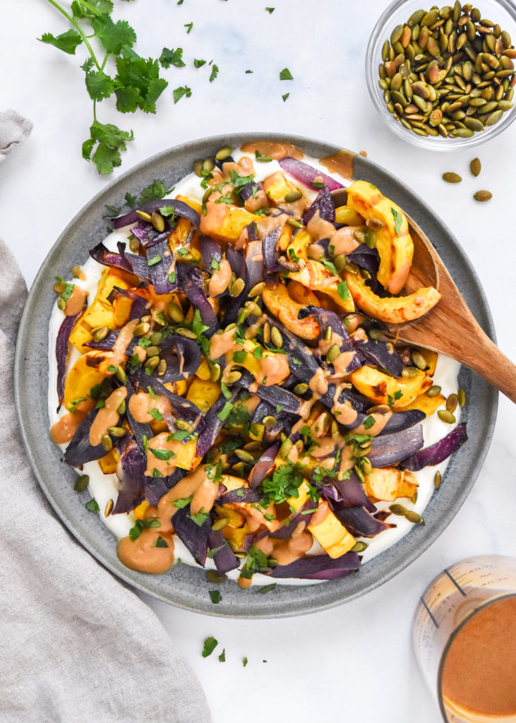 Air Fryer Butternut Squash Fries (Crispy, Healthy & Ready in 25 Minutes) 11 Butternut squash cut into uniform fry-shaped sticks on a wooden cutting board, surrounded by small bowls of smoked paprika, cumin, olive oil, and Greek yogurt