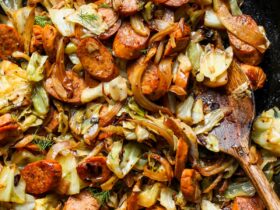 Cabbage and sausage skillet in a cast-iron pan with golden caramelized cabbage and sliced smoked sausage, garnished with fresh parsley