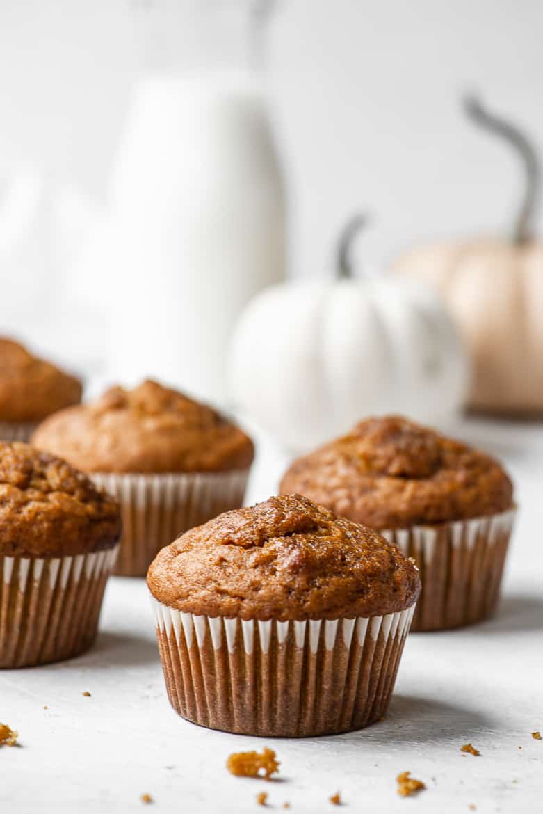 Greek Yogurt Pumpkin Muffins — Moist, Wholesome & Naturally Sweet 12 Close-up of a halved Greek yogurt pumpkin muffin showing moist, tender crumb with visible specks of spice, on a linen napkin
