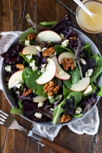 Healthy October Harvest Salad — Crisp, Colorful & Nourishing 13 Healthy October harvest salad with green apple, candied walnuts, blue cheese, and lemon vinaigrette in a large wooden bowl, overhead shot on a rustic autumn table