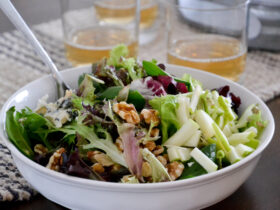 Healthy October Harvest Salad — Crisp, Colorful & Nourishing 16 Close-up of a single serving of the October harvest salad in a white bowl, showing julienned apple ribbons, candied walnuts, and blue cheese crumbles with lemon vinaigrette drizzle