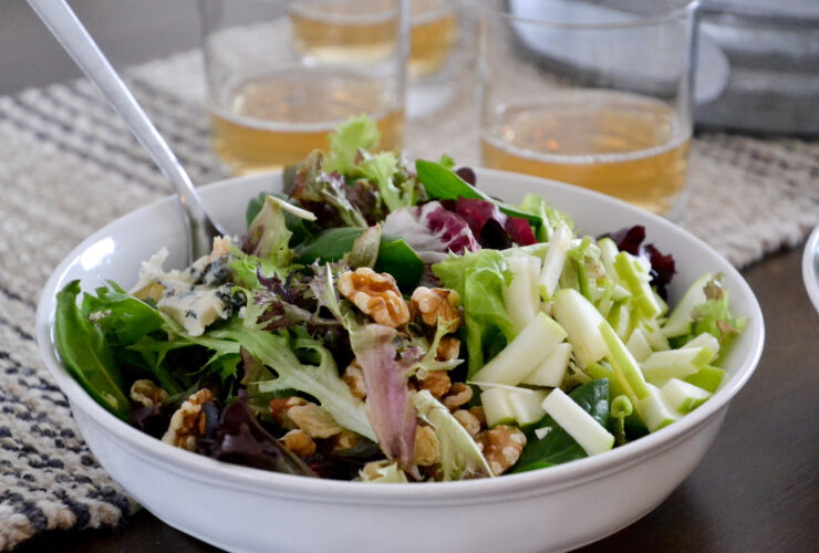 Healthy October Harvest Salad — Crisp, Colorful & Nourishing 9 Close-up of a single serving of the October harvest salad in a white bowl, showing julienned apple ribbons, candied walnuts, and blue cheese crumbles with lemon vinaigrette drizzle