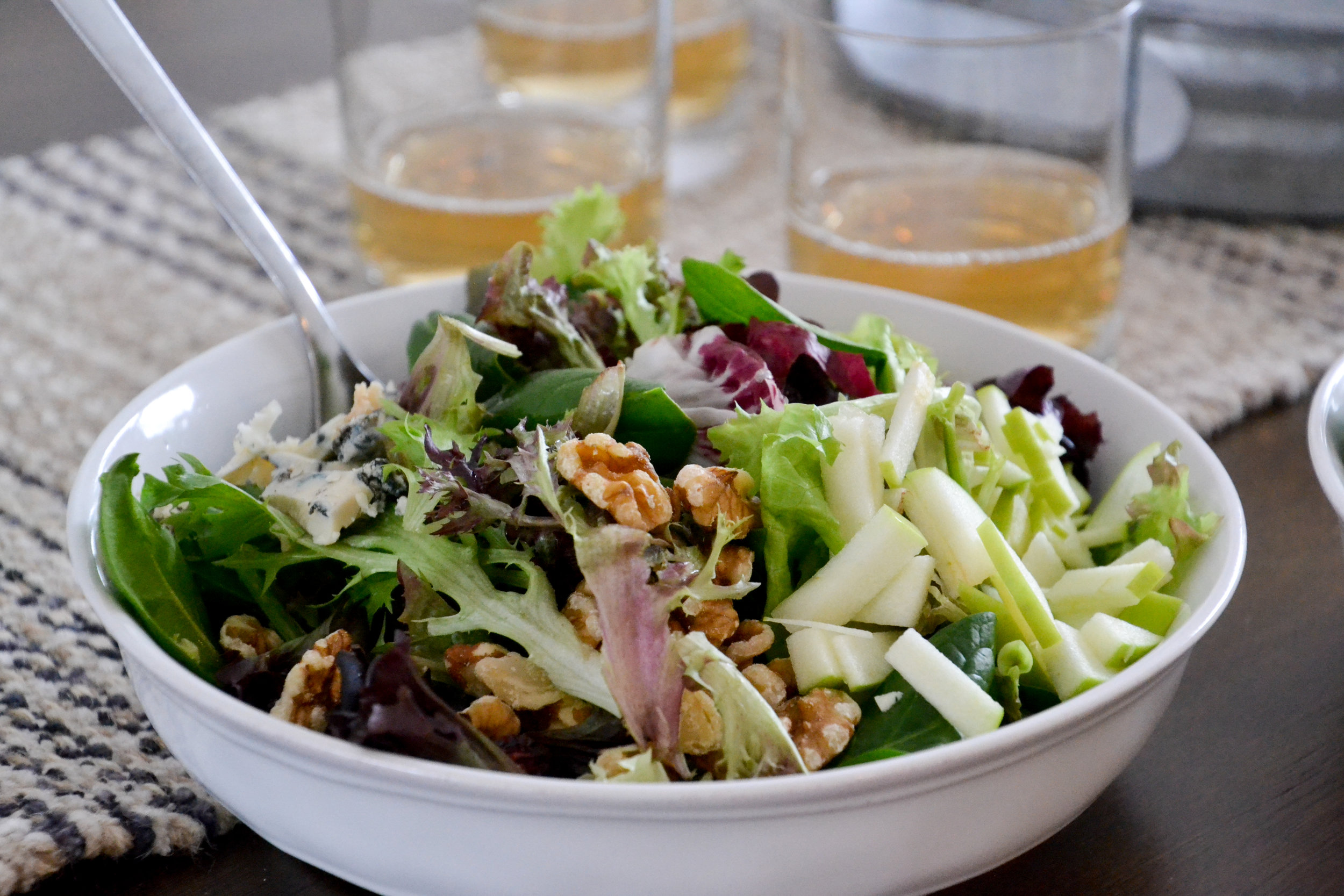 Healthy October Harvest Salad — Crisp, Colorful & Nourishing 12 Close-up of a single serving of the October harvest salad in a white bowl, showing julienned apple ribbons, candied walnuts, and blue cheese crumbles with lemon vinaigrette drizzle
