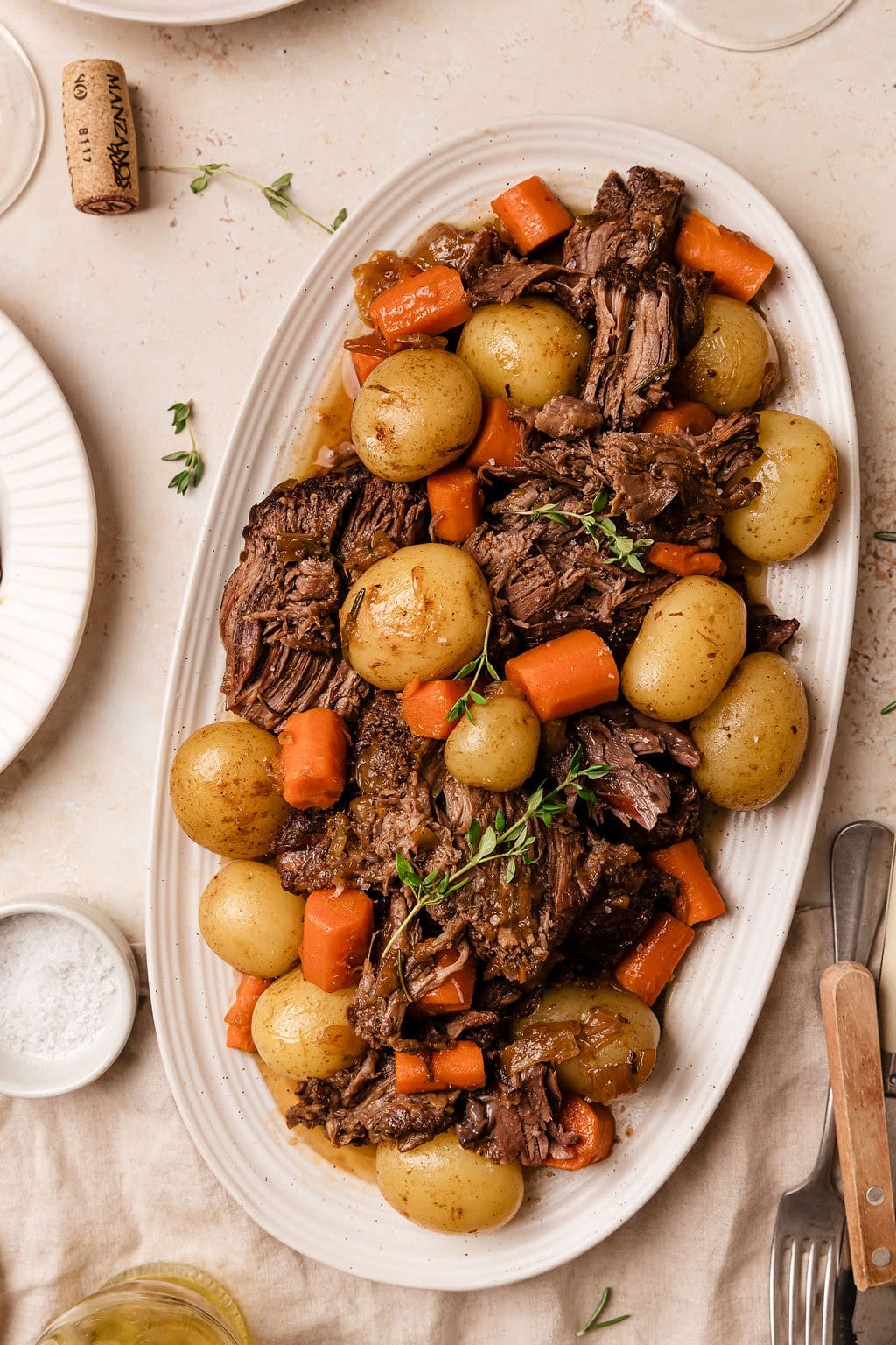Lighter Beef Pot Roast — Clean, Nourishing & Fall-Apart Tender 10 Lighter beef pot roast with root vegetables and rich broth served in a rustic Dutch oven on a wooden table