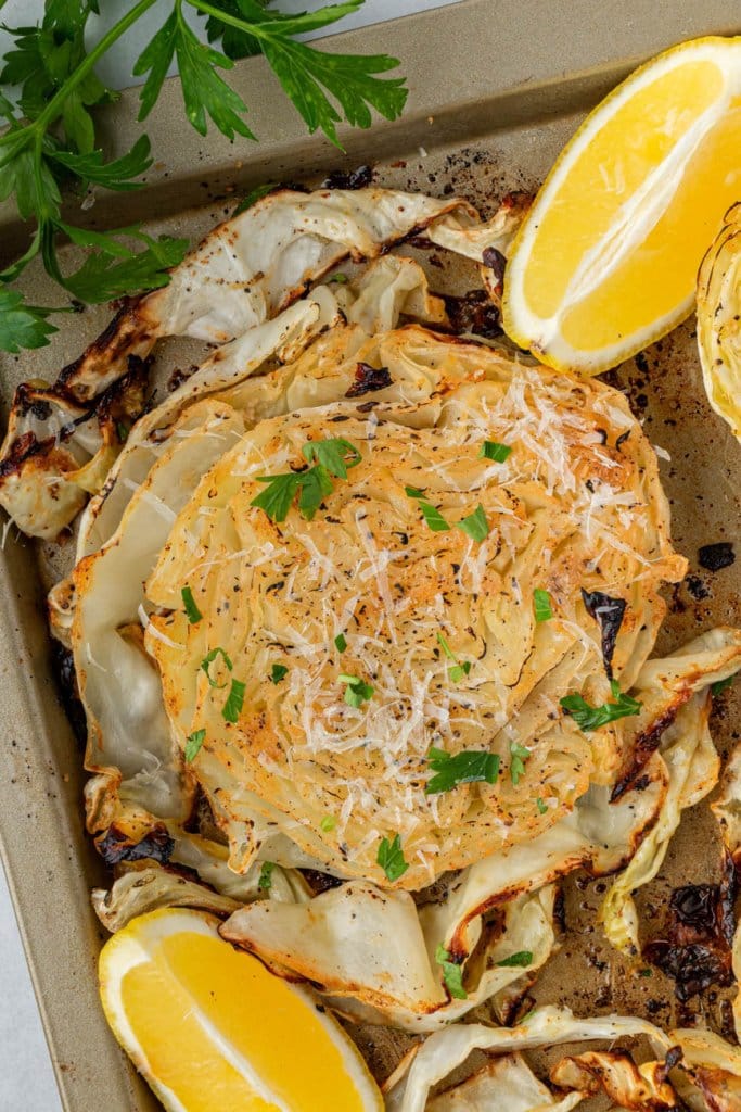 Roasted Cabbage Steaks — Crispy-Edged, Caramelized & Surprisingly Addictive 26 Roasted cabbage steaks on a sheet pan with crispy golden edges, drizzled with olive oil and garnished with fresh parsley