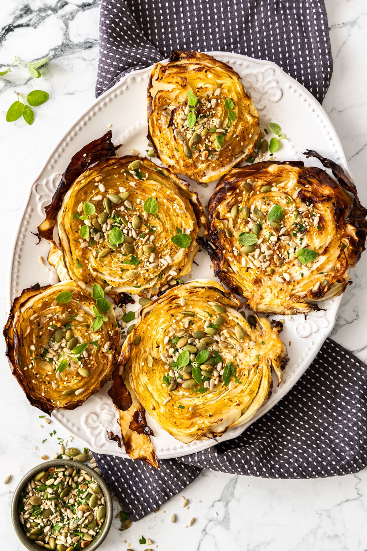 Roasted Cabbage Steaks — Crispy-Edged, Caramelized & Surprisingly Addictive 27 Overhead flat-lay of sliced cabbage rounds, olive oil, smoked paprika, garlic, salt, and lemon on a white marble surface
