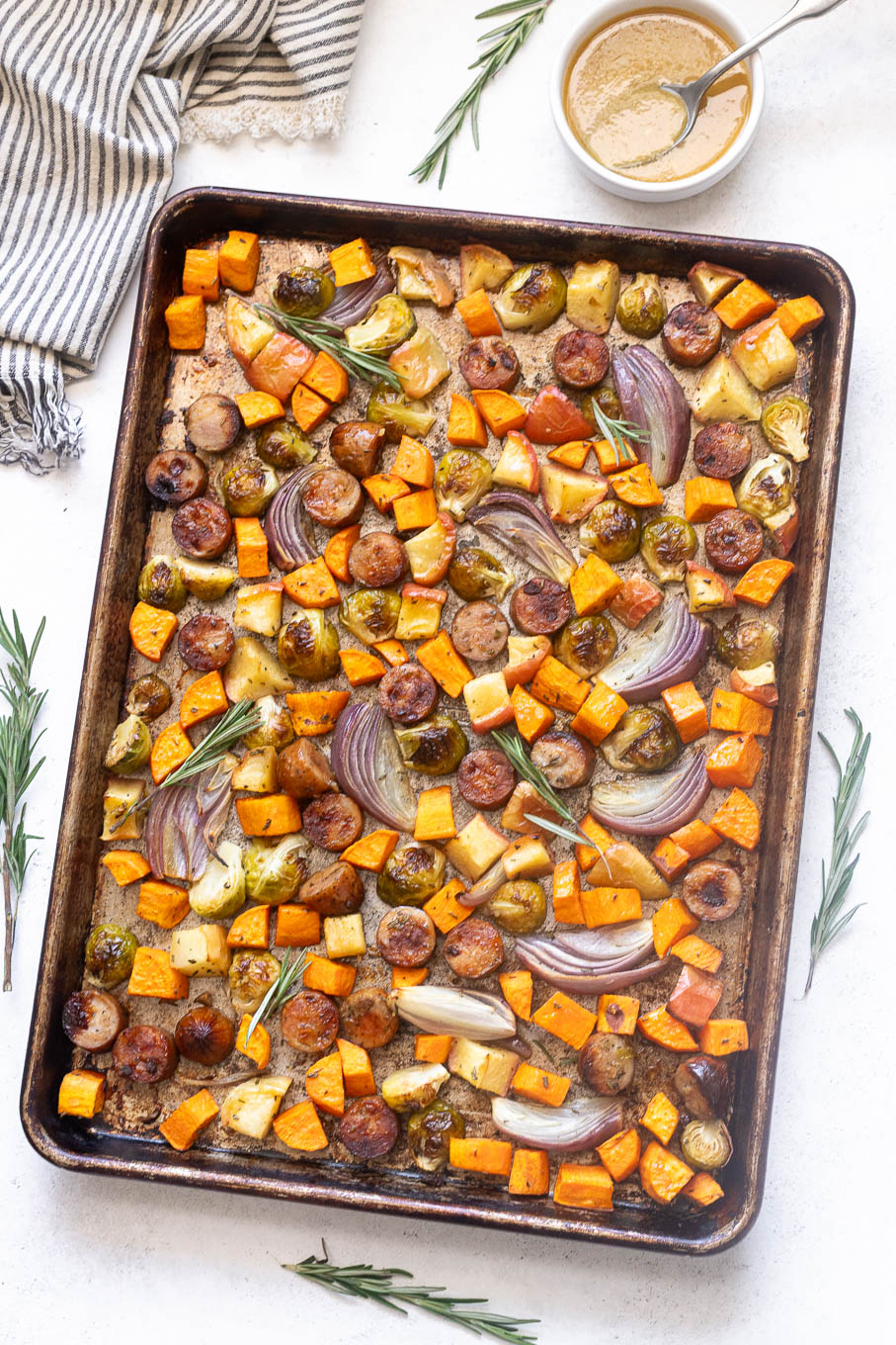 Sheet Pan Turkey Sausage and Fall Vegetables — Easy, Nourishing One-Pan Dinner 11 Overhead flat-lay of raw sheet pan turkey sausage fall vegetables ingredients — sliced delicata squash, cubed sweet potato, halved Brussels sprouts, and raw sausage links arranged on a pan before roasting